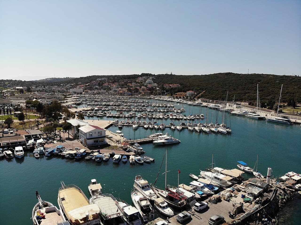 Aerial view of a marina with yachts berthed along the pontoons